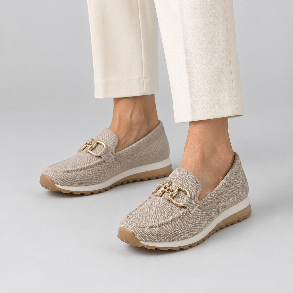 Woman wearing the Lili cushioned loafer sneakers with gold horsebit detail